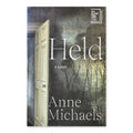 Held by Anne Michaels, hardcover, front cover